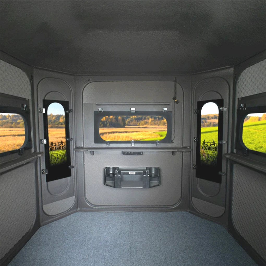 Interior of the 6'x7' Big Country Platinum 360 looking toward the front windows, showing the pre-installed gear console and the marine-carpeted floor.