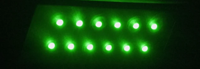 3-way green LED under-shelf light, illuminated.