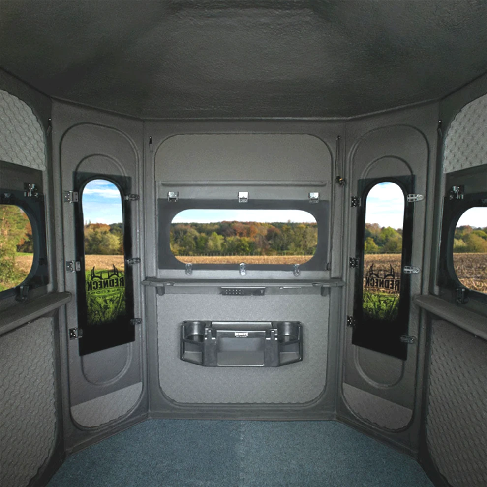Interior of the 5'x6' Predator Platinum 360 looking toward the front windows, showing the pre-installed gear console and the marine-carpeted floor.